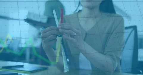 Image of financial data processing over asian businesswoman holding samples Stock Photos