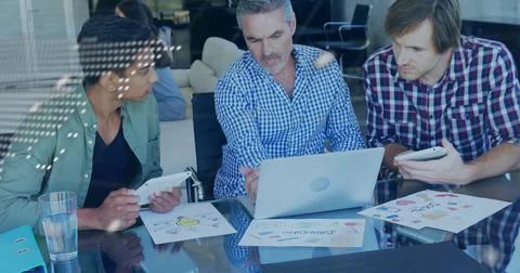 Image of financial data processing over diverse colleagues discussing work in Stock Photos