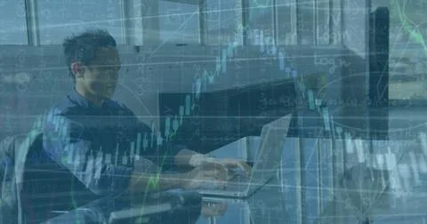 Image of financial data processing over asian male engineer using laptop at Stock Photos