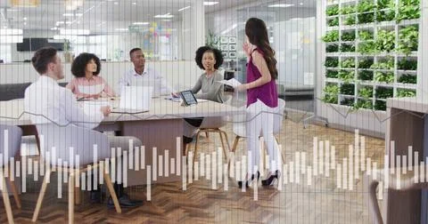 Image of financial data processing over diverse business people in office Stock Photos