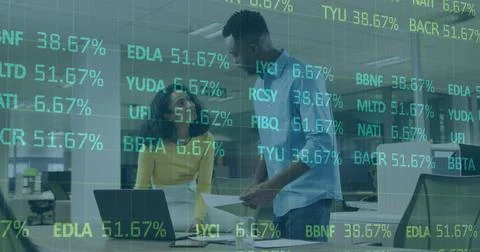 Image of financial data processing over diverse business people using laptop in Stock Photos