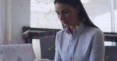Image of financial data processing over caucasian businesswoman using laptop in Stock Photos