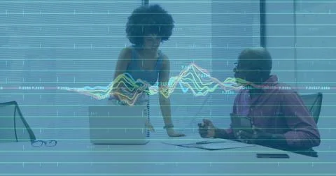 Image of financial data processing over diverse business people working at Stock Photos