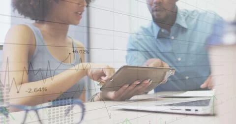 Image of financial data processing over diverse business people using tablet in Stock Photos