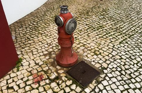 Image of a fire hydrant guard installed on the outside of a building Stock Photos