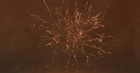 Image of fireworks exploding on brown background 写真素材