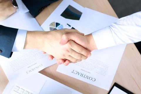 Image of a firm handshake between two colleagues after signing a contract Stock Photos