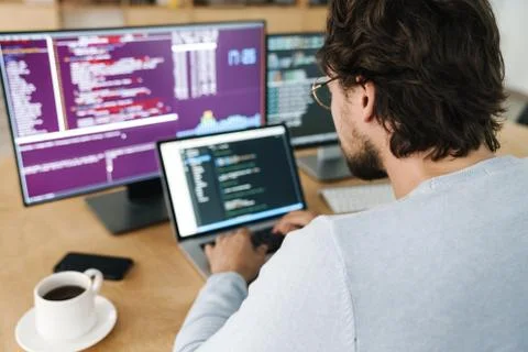 Image of focused caucasian programmer man working with computers Stock Photos
