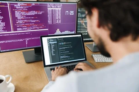 Image of focused caucasian programmer man working with computers Stock Photos