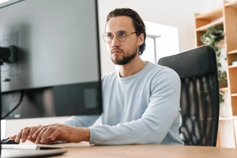Image of focused unshaven programmer man working with computer Stock Photos