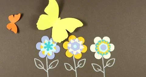 Image frame background of blooming paper flowers on a colored background. Stock Photos