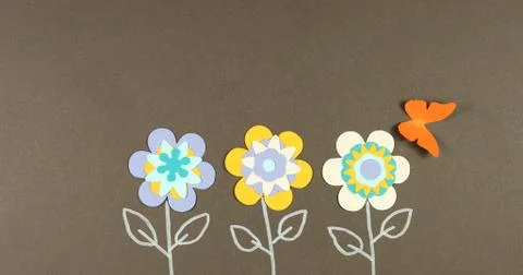 Image frame background of blooming paper flowers on a colored background. Stock Photos