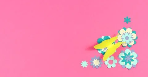 Image frame background of blooming paper flowers on a colored background. Stock Photos