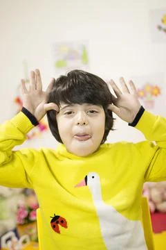 Image of a funny boy with a silly expression, teasing his friend - isolated Stock Photos
