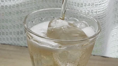 Image of ginger ale on a table by the window Stock Footage 285280736