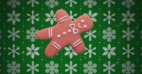 Image of ginger bread cookie over snow pattern on green background Illustrazione stock