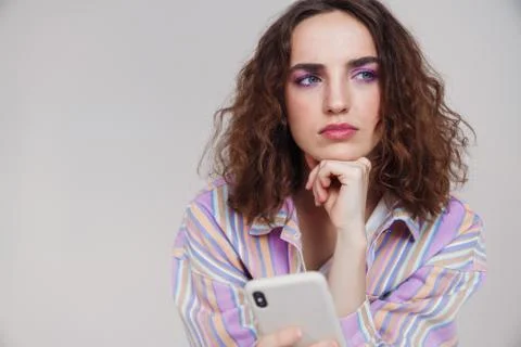 Image of ginger brooding woman thinking and using smartphone Fotos de archivo