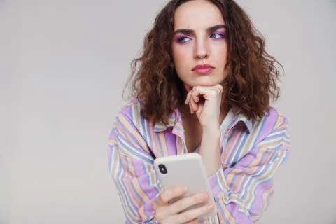 Image of ginger brooding woman thinking and using smartphone Fotos de archivo