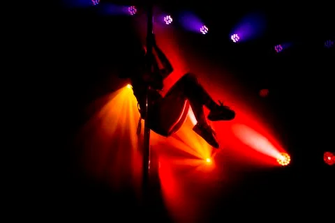 Image of girl preforming dance on a pole in a night club. . Stock Photos