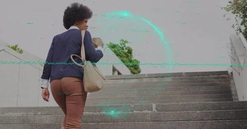 Image of globe and business data over african american woman using smartphone Stock Photos