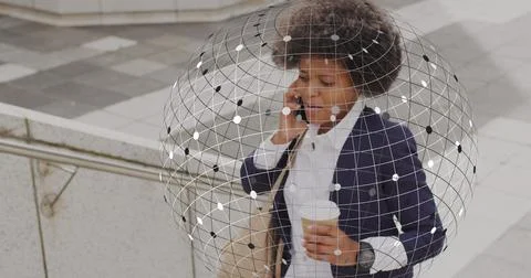 Image of globe and business data over african american woman using smartphone Foto stock