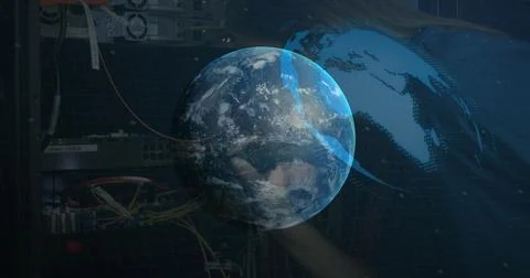 Image of globe rotating over integrated circuit on black background Stock Photos