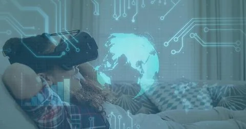 Image of globe spinning and processor elements over smiling boy wearing vr Stock Photos