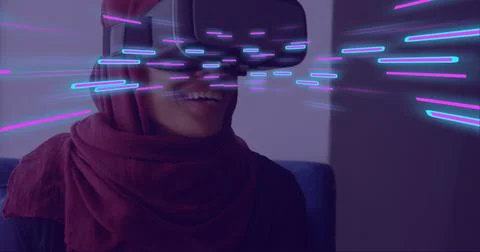 Image of glowing light trails of data transfer over woman in vr headset Stock Photos