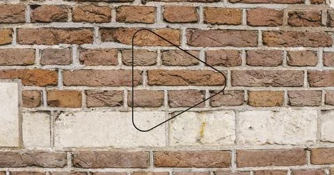 Image of glowing neon arrow icon on brick wall Stock Photos
