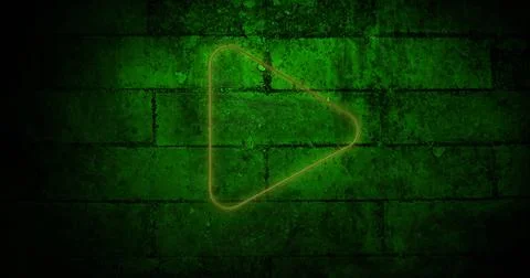 Image of glowing neon play button icon on brick wall Stock Photos