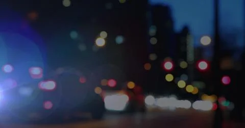 Image of glowing spots of light over out of focus city background Stock Illustration