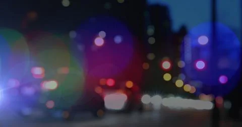 Image of glowing spots of light over out of focus city background 스톡 일러스트