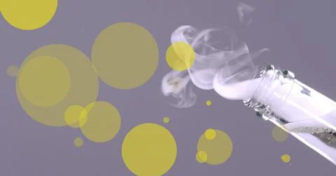 Image of glowing yellow spots falling over champagne cork exploding from bottle Foto stock