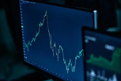 Image is a graph of financial development on a computer monitor. Stock Photos