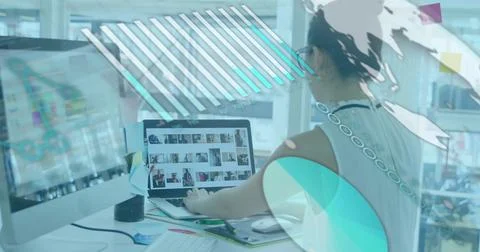 Image of graph, globe and computer language over asian woman working on laptop Stock Photos