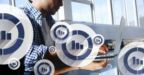 Image of graph icon in circles over latino man typing on keyboard of laptop in Stock Photos