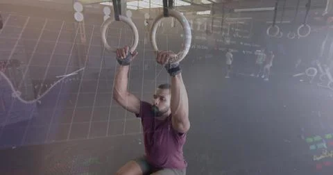 Image of graph processing data over biracial man cross training on gym rings at Stock Photos