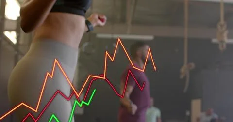Image of graph processing data over diverse woman and man jumping rope cross 스톡 사진