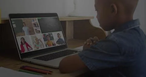 Image of graphs and binary code over african american boy having online lessons 스톡 사진