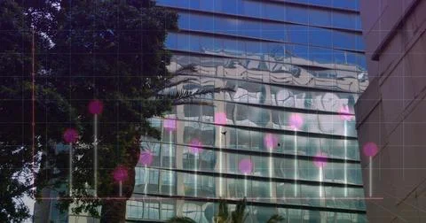 Image of graphs and computer language over modern buildings against sky Foto stock