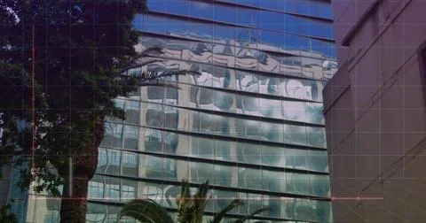 Image of graphs and computer language over modern buildings against sky 스톡 사진