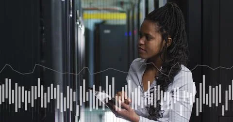 Image of graphs and data over african american woman in server room Stockfoto's