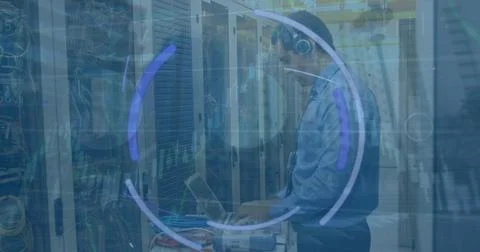 Image of graphs and eye over caucasian man checking servers 스톡 사진