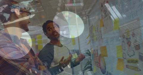 Image of graphs and financial data over diverse coworkers brainstorming in Stockfoto's