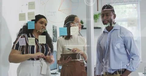Image of graphs and loading circles over diverse coworkers discussing strat.. Stock Photos