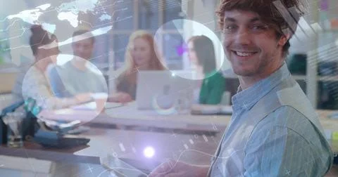 Image of graphs, data and digital interface over smiling man using tablet Stock Photos
