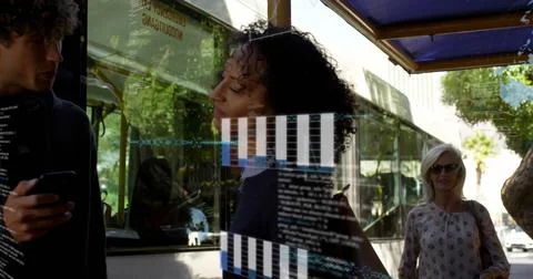 Image of graphs, globes and computer language, diverse friends talking at bus Foto stock