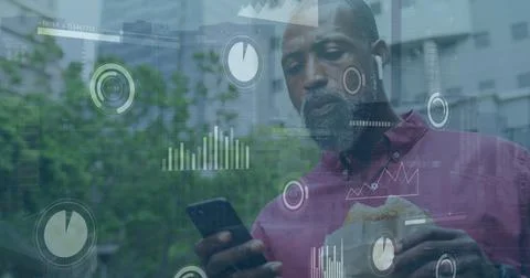 Image of graphs, loading bars, circles, african american man using cellphone and Foto stock