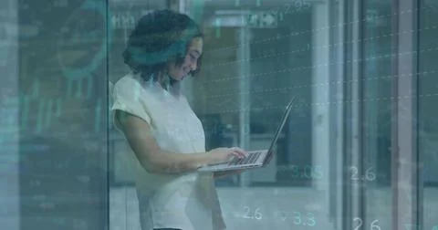Image of graphs, trading board, loading circles, biracial woman standing an.. Stock Photos