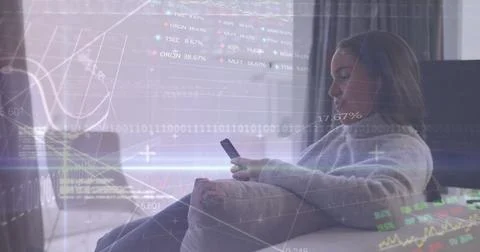 Image of graphs, trading boards, binary codes, biracial woman using smartphone Stock Photos